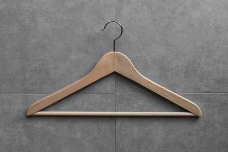 Clothing hanger on cement wall backgroundの写真素材