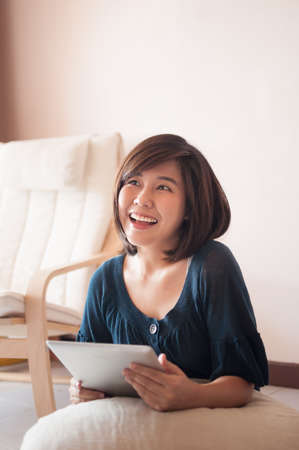 Young asian woman holding blank digital tablet.の写真素材