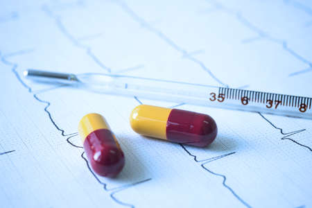 Medical pills thermometer and cardiograph.