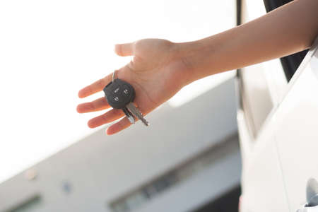 Hand holding car key outside.の写真素材