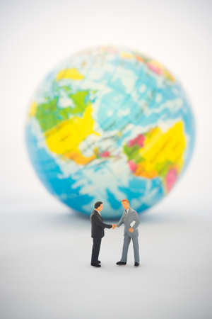 Businessman hand shaking in front of  the global, International business deal.の写真素材