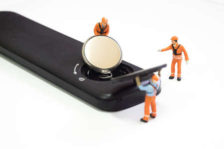 Worker loading battery to remote control.の写真素材
