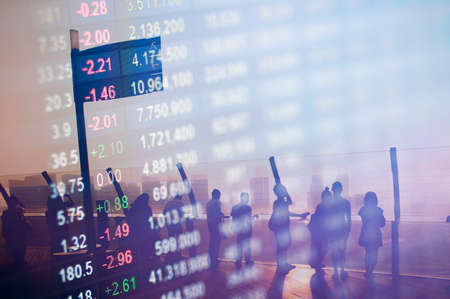 Stock market number overlay on silhouette people meeting.の写真素材
