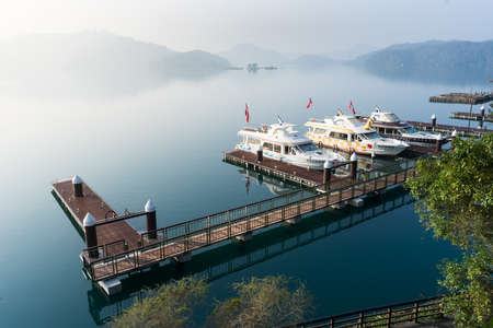 Nantou, Taiwan - March 02, 2016 : Tourist boats docking in peachful morning at Shuishe Pier, Sun Moon Lake, Taiwan.のeditorial素材