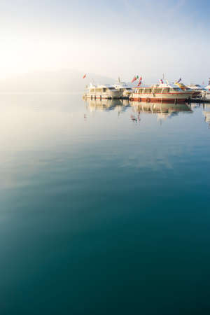 Nantou, Taiwan - March 02, 2016 : Tourist boats docking in peachful morning at Shuishe Pier, Sun Moon Lake, Taiwan.のeditorial素材
