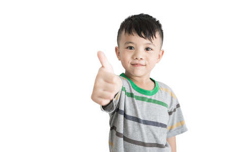 Boy giving thumb up isolated on white backgroundの写真素材