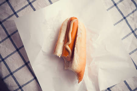 Hot Dog bite left on paperの写真素材