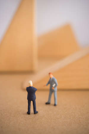 Businessman thinking or making decision in front of wood block shape.の写真素材