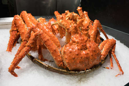 Fresh Red King Crab in basket at seafood market.