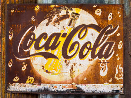 Bangkok, Thailand - May 13, 2016 : Grunge rusty retro vintage Coca-Cola advertising metal board sign.のeditorial素材
