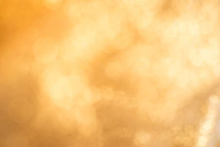 Gold Lights Festive background. Abstract bright background with bokeh defocused gold lightsの写真素材