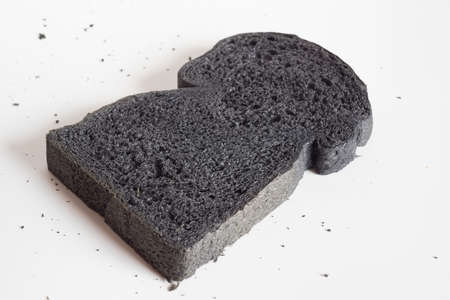 Black charcoal bread on white background.の写真素材