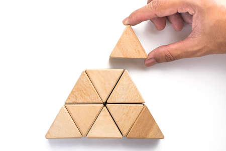Triangles wood block arranging as stack step can use for business template or bullet or infographic. Wood block on white background.の写真素材