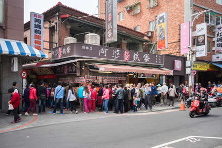 Tamsui, Taiwan - March 05, 2016 : Many cutomer waiting for buy Tamsui Iron Egg from famous shop.のeditorial素材