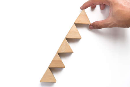 Hand arranging wood block stacking as step stair can use for business presentation template or bullet or infographics. Business concept for growth success process.の写真素材