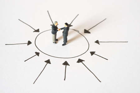 Business concept of Center management. Businessmen handshaking at center of arrow pointの写真素材