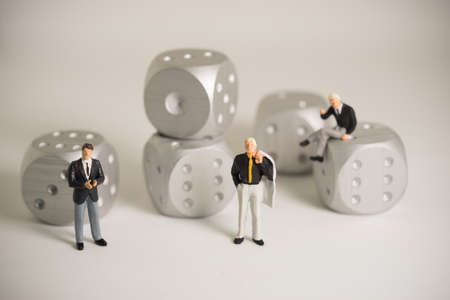 Concept of business risk. Businessmen standing with rolling dice.の写真素材
