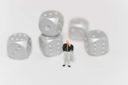 Concept of business risk. Businessman standing with rolling dice.の写真素材