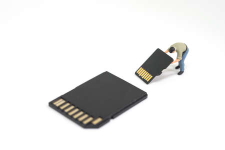 Concept of data recovery. Worker working on micro sd card.