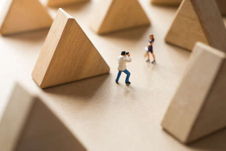 Couple traveler taking photo with triangle wood block scene.の写真素材