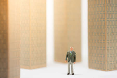 Concept of business career. Senior businessman standing with surrounded building.の写真素材