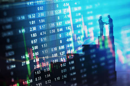Concept of stock market strategy. Stock market number on screen display with businessman shakinghandsの写真素材
