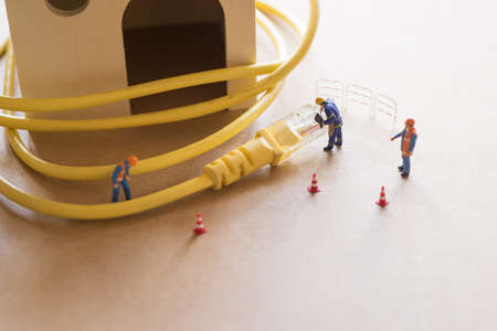 Concept of network troubleshoot supporter or administrator. Internet connection support team fixing LAN cable.の写真素材