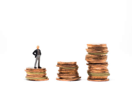 Concept of success business. Casual senior businessman standing on coin stack step.の写真素材
