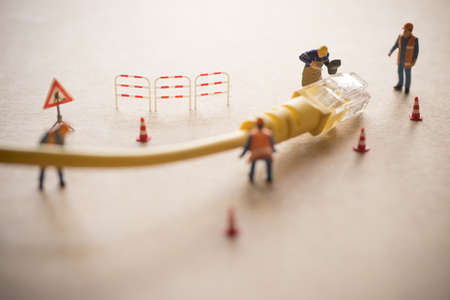 Concept of network troubleshoot supporter or administrator. Internet connection support team fixing LAN cable.の写真素材