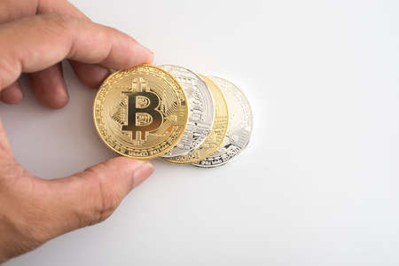 Hand picking Golden Bitcoin Cryptocurrencyのeditorial素材
