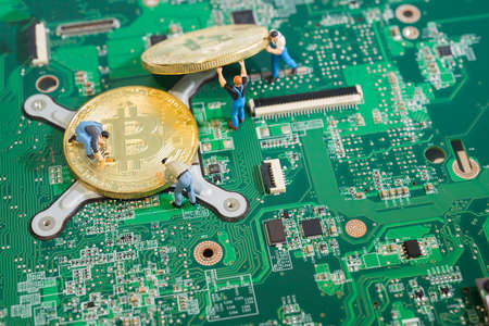 Workers work on computer circuit board moving Bitcoin Cryptocurrency mining concept.のeditorial素材