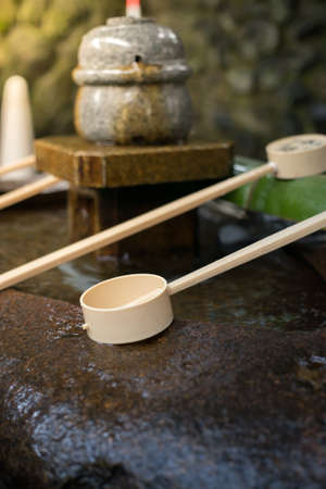 Mouth and hand washing bucket in front of Shrine or Temple.の写真素材