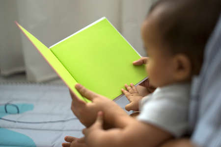 Mother and baby reading a fable tale story, empty space for editing.の写真素材