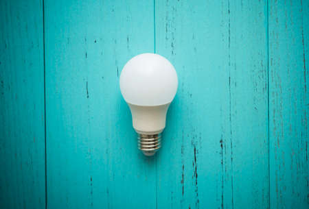 LED light bulb on shabby wood background.の写真素材