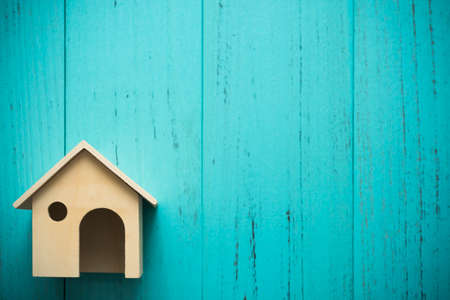 Miniature wood house on grunge background with copyspaceの写真素材