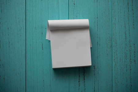 White note paper on grungy wood tableの写真素材