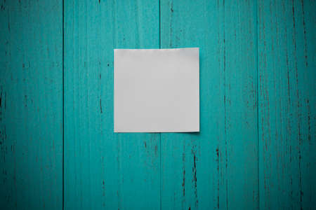 White note paper on grungy wood tableの写真素材