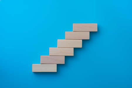 Wood block stacking as step stair. Business concept for growth success process.の写真素材