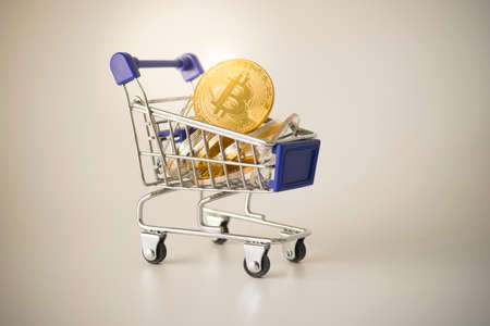 Golden Bitcoin in shopping cart. Bitcoin Cryptocurrency.の写真素材