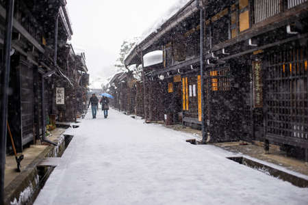 Takayama, Japan - February 12, 2017 : Tourist walking at Takayama Old Town Street in winter snow. のeditorial素材