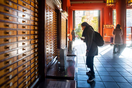 Tokyo, Japan - February 16, 2017 : Tourist doing fortune teller at Sensoji Temple .のeditorial素材