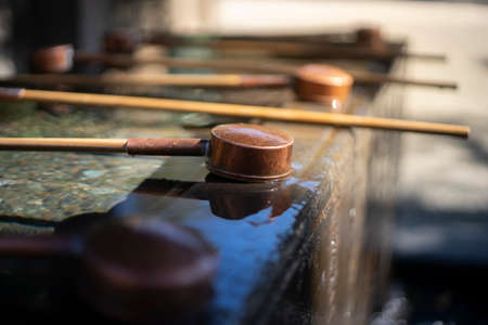 Mouth and hand washing bucket in front of Shrine or Temple.の写真素材