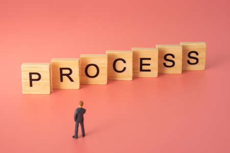 Businessman standing in front of process text. Concept of business process.の写真素材