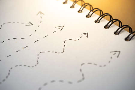 Different arrow path draw on white paper.の写真素材