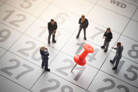 Businessmen with pinned calendar. Business appointment or decision conceptの写真素材