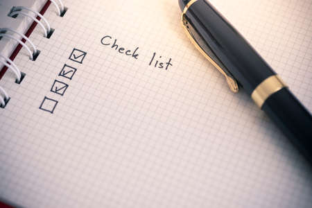 Check list writing on business notebook paperの写真素材