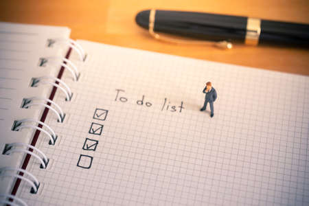 Businessman thinking with to do list on notebook paperの写真素材