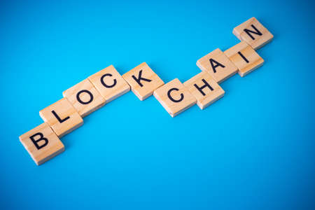 Workers arranging wood with text Blockchain.