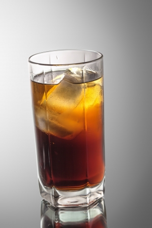 cocktails rum-cola with ice on a gray gradient backgroundの写真素材