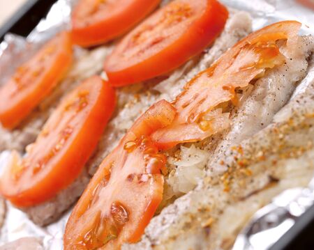 the tomatoes cut with rings on pieces of meat.の写真素材